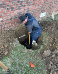 A and D Plumber digging in customer's yard exposing piping