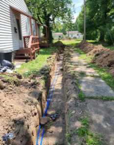 A and D plumbing trench dug through customer yard laying water lines